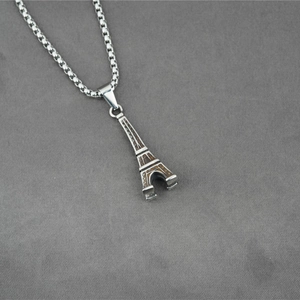 Eiffel Tower pendant necklace in stainless steel with brown texture on grey fabric