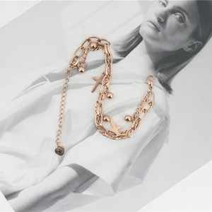 Double-layered rose gold titanium bracelet with cross pendants and small metal beads