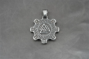 Detailed close-up of a silver Valknut gear pendant with Viking runes on grey fabric