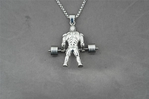 Dettaglio macro del ciondolo fitness argento con bodybuilder e catena a maglia quadrata