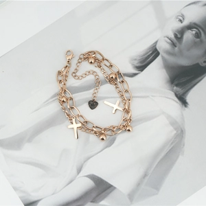 Double-layered rose gold cross bracelet with metal beads and heart charm
