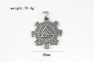 Macro shot of gear-shaped Viking pendant with Valknut symbol and Futhark runes