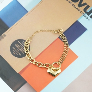 Gold-tone heart pendant bracelet featuring unique mixed cable and curb chain design