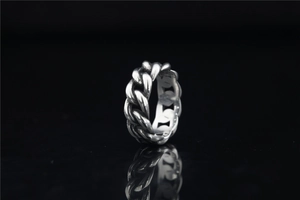 Macro view of vintage Cuban link twisted silver steel ring with oxidized finish