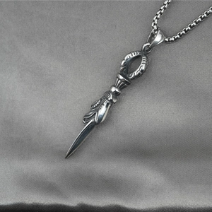 Vintage stainless steel dagger pendant necklace with intricate carvings on silver chain