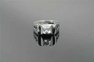 Macro detail of men's square diamond titanium ring with wavy black carved side lines