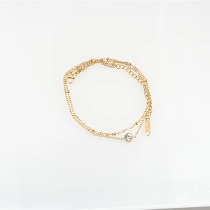 Double-layered gold titanium steel bracelet featuring a round zircon and bead chain