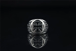 Macro shot of vintage cross pattern on stainless steel ring with polished details