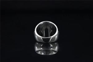 Macro view of polished stainless steel wide band ring with silver mirror finish