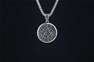 Macro detail of vintage stainless steel Freemasonry pendant with G symbol and square