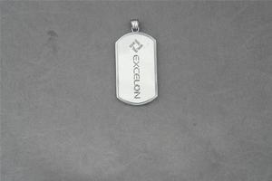 Close-up of polished stainless steel dog tag pendant with Excelon brand engraving