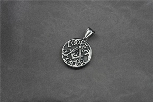 Detail of vintage silver titanium steel Masonic pendant with engraved G and compass design