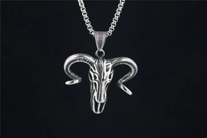 Detailed close-up of a vintage bull skull pendant with intricate textures and chain
