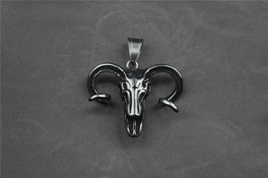 Macro shot of vintage steel ram skull pendant with gothic textures and spiral horns