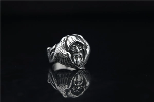 Detailed macro view of a vintage silver Nordic wolf ring with mythical elder engraving