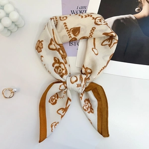 Detail of elegant French silk-feel square scarf tied in a bow with vintage rose pattern
