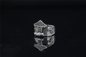 Detailed macro view of vintage Viking Thor's Hammer ring with intricate relief engraving