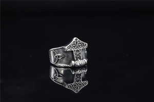 Detailed macro shot of vintage Viking Mjölnir hammer ring with Celtic knots in steel