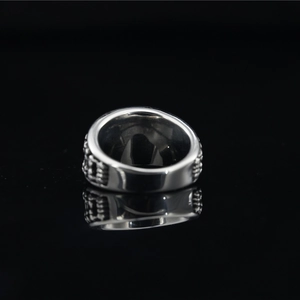Vintage silver steel ring with turquoise sun pattern and relief texture on black mirror