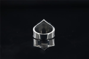 Macro view of polished silver viking totem ring featuring sharp angular geometric design
