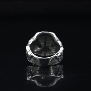 Retro Nordic wolf ring in vintage silver finish with feather texture on black background