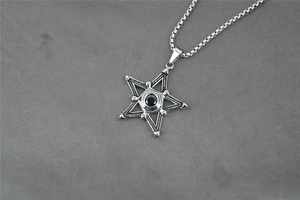 Macro shot of punk style hexagram pendant with black gem on titanium steel square chain