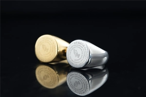 Macro shot of Serenity Prayer and Praying Hands engraved on round signet rings
