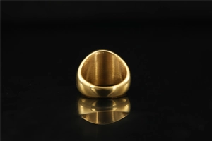 Macro shot of wide gold band ring with brushed metal interior and mirror polished finish