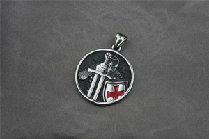 Close-up of Knights Templar pendant with red cross and sword detail on silver steel