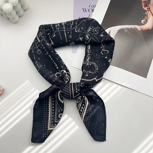 Detail of vintage paisley silk scarf tied in a bow with classic key and chain patterns