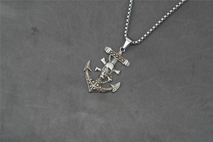 Detailed view of punk pirate anchor pendant with skull and crossbones in vintage steel