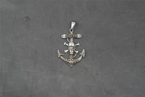 Detailed close-up of a vintage pirate anchor pendant with a central 3D skull and crossbones