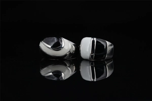 Detail of minimalist black and white enamel inlay on polished titanium steel rings
