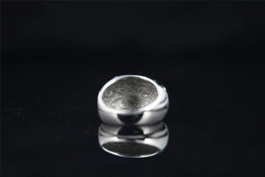 Macro detail of the inner hammered texture on a silver titanium steel minimalist ring