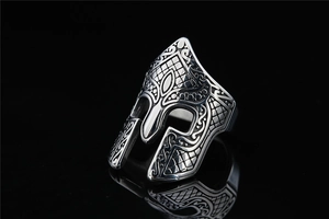 Detailed close-up of a silver Spartan helmet ring with vintage engraved patterns