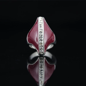 Vintage silver-tone wide ring with red enamel inlay and crystals on black background