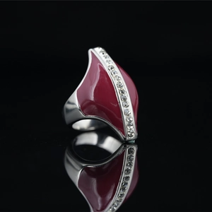 Vintage steel ring with red enamel inlay and vertical zircon stones on black reflection