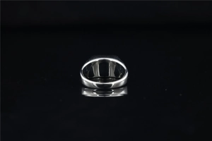 Macro shot of polished silver titanium steel ring with a smooth mirror finish for men