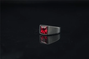 Macro shot of square red ruby gemstone set in a matte black brushed titanium band