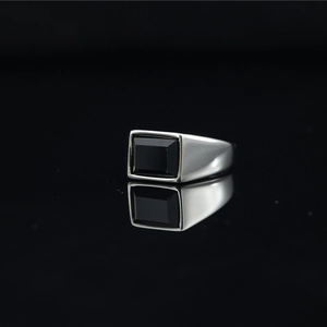 Minimalist titanium steel ring with a rectangular black gemstone and mirror reflection