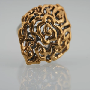 Retro hollow rose pattern ring in vintage gold finish with detailed 3D carving