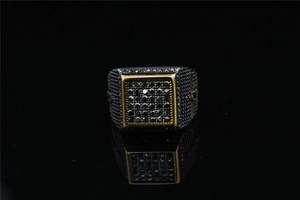 Macro detail of square hip-hop ring featuring black gemstones and gold-tone metal borders