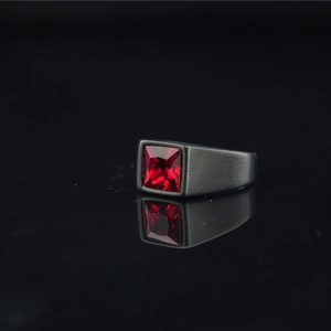 Men's black brushed stainless steel ring with square red gemstone on black background