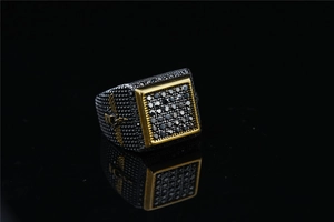 Detailed macro view of gothic square signet ring with black crystals and gold sword motif