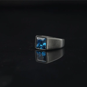 Titanium steel ring with square blue gemstone and brushed matte finish on black surface