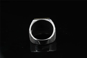 Macro side view of square titanium ring with textured non-slip industrial grain pattern