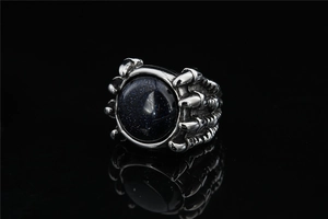 Macro view of gothic claw ring featuring a sparkling blue sandstone and vintage silver finish