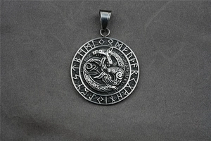 Detailed view of vintage Viking pendant with dragon totem and Nordic runes on metal