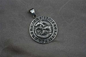 Macro shot of a Viking rune pendant with dragon totem in vintage stainless steel finish