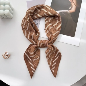 Detail of soft brown and beige silk-feel square scarf with geometric pattern